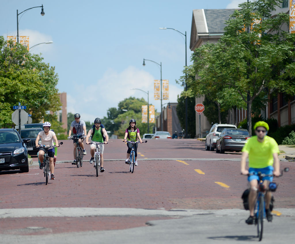Rachel Finney, Andy Overmann, Tyler Tuschhoff, Tessa Tuschhoff and Robert Overmann cycle down Cherry Street